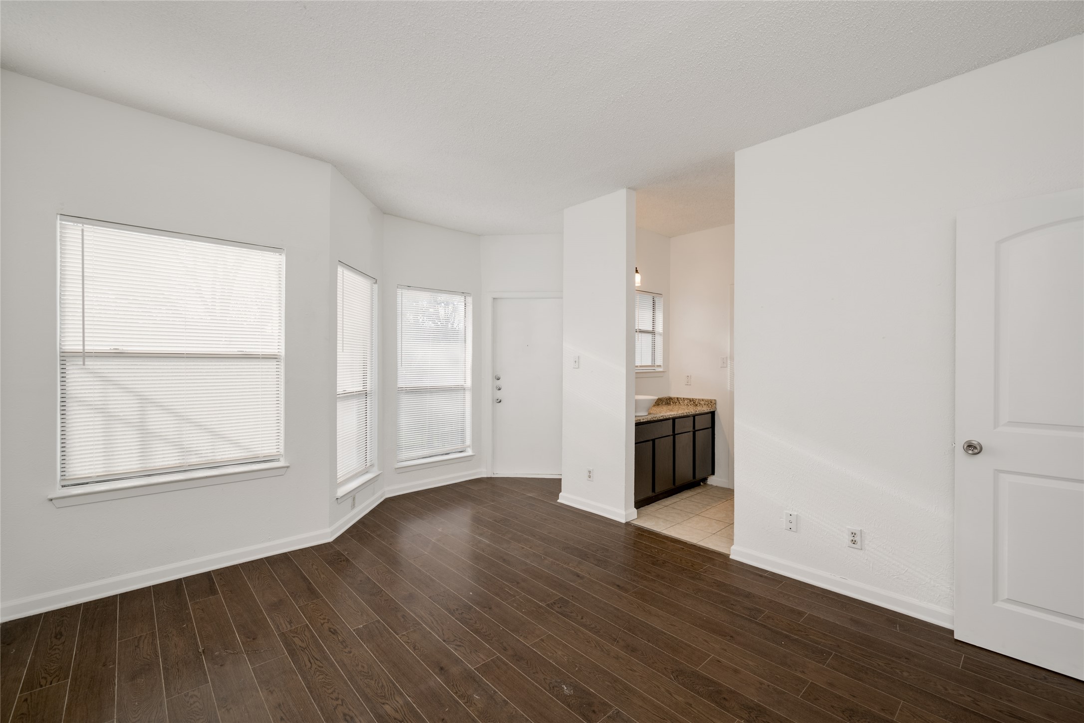 5304 Indio Cove, Unit B Austin, TX 78745 - Photo 16 of 40 an empty room with wooden floor and windows