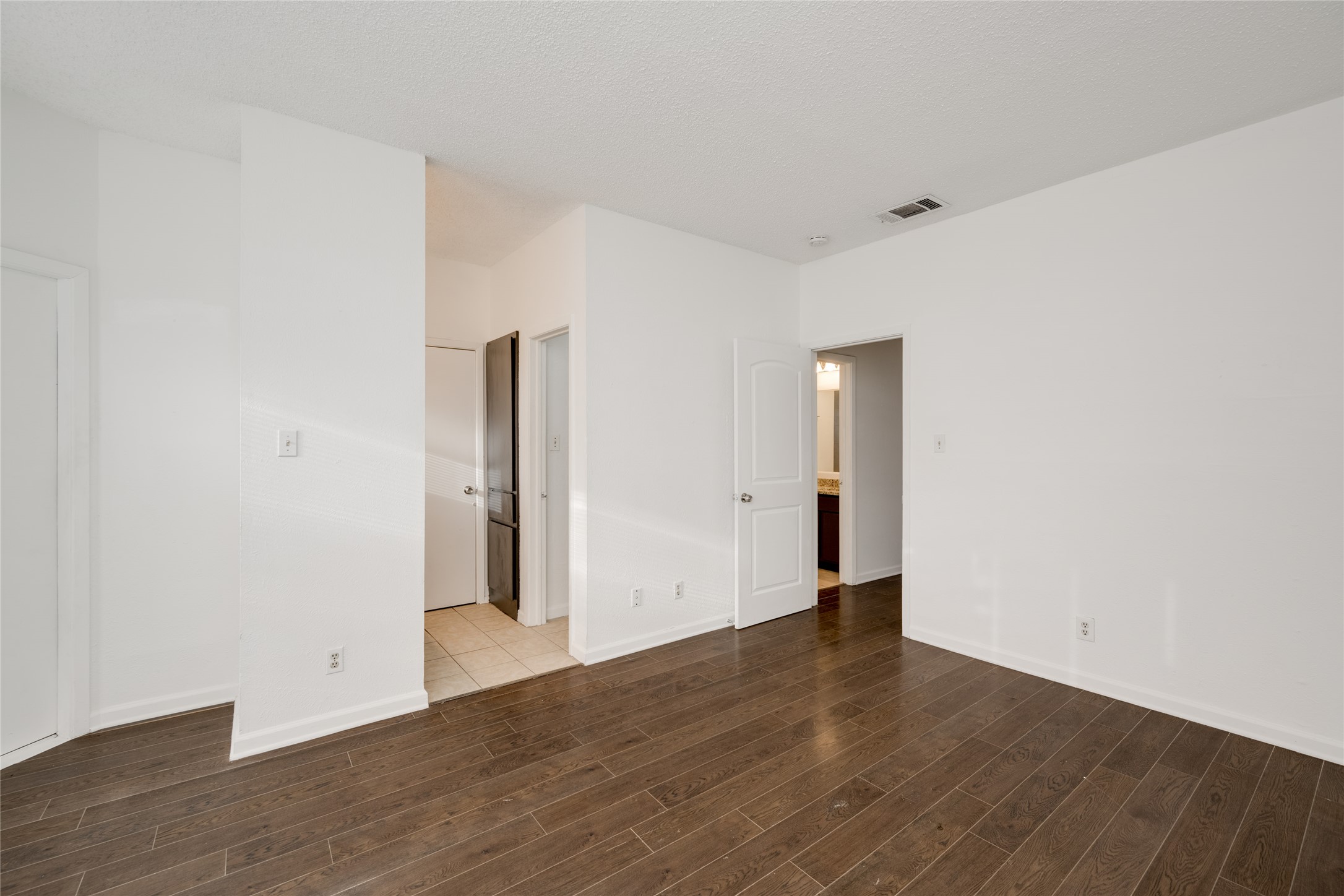 5304 Indio Cove, Unit B Austin, TX 78745 - Photo 17 of 40 a view of an empty room with wooden floor and closet