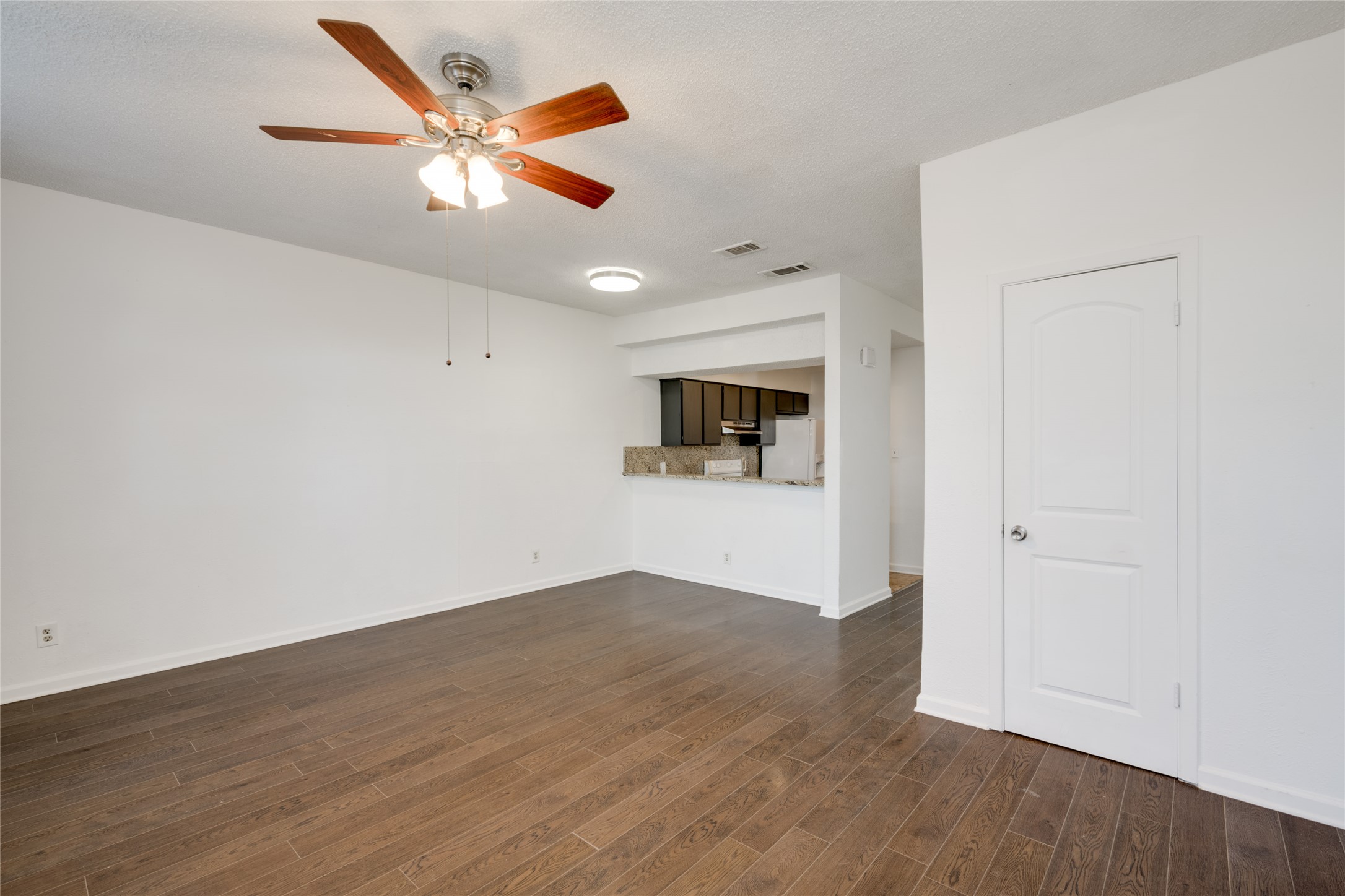 5304 Indio Cove, Unit B Austin, TX 78745 - Photo 2 of 40 an empty room with wooden floor and ceiling fan