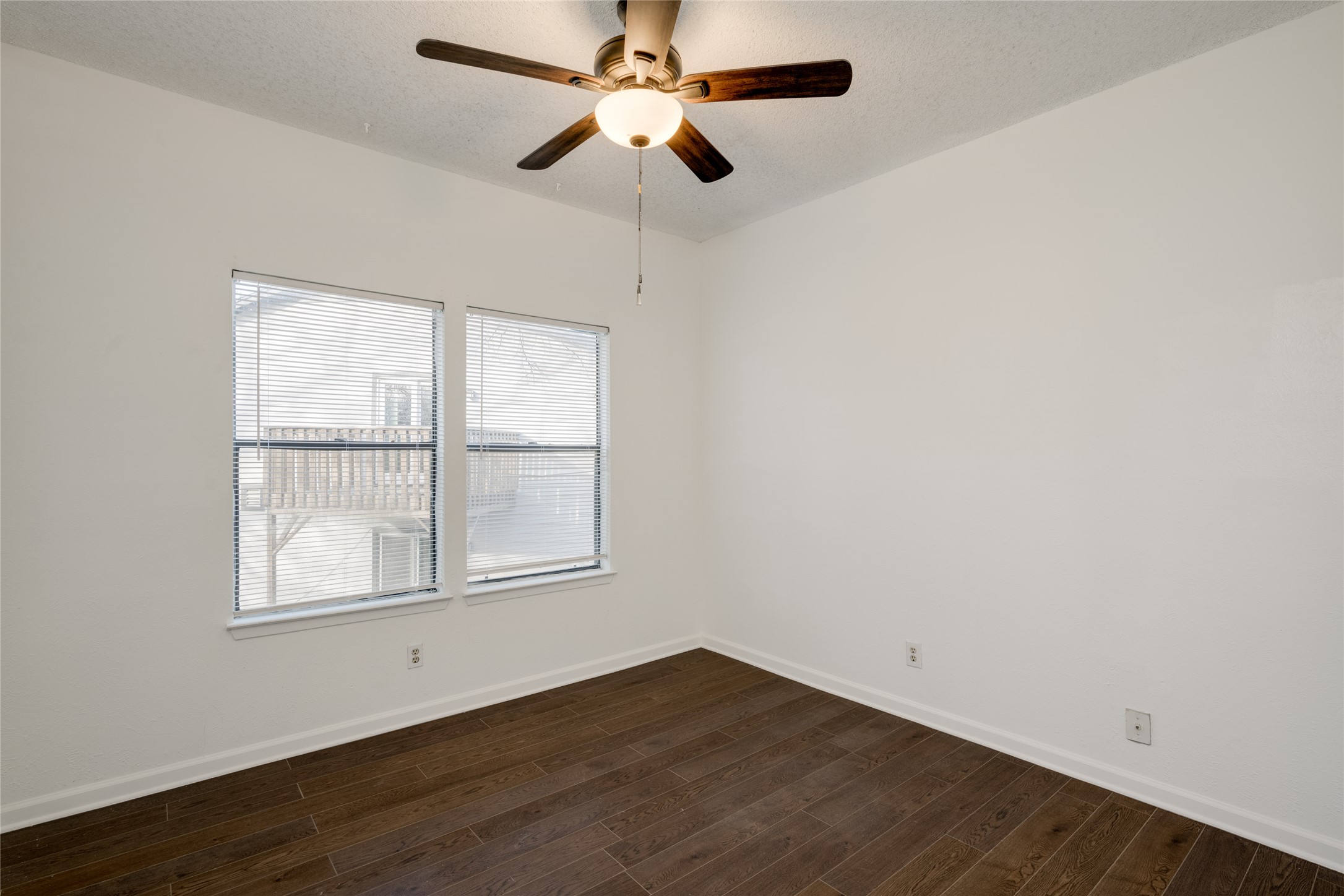 5304 Indio Cove, Unit B Austin, TX 78745 - Photo 21 of 40 an empty room with wooden floor chandelier fan and windows