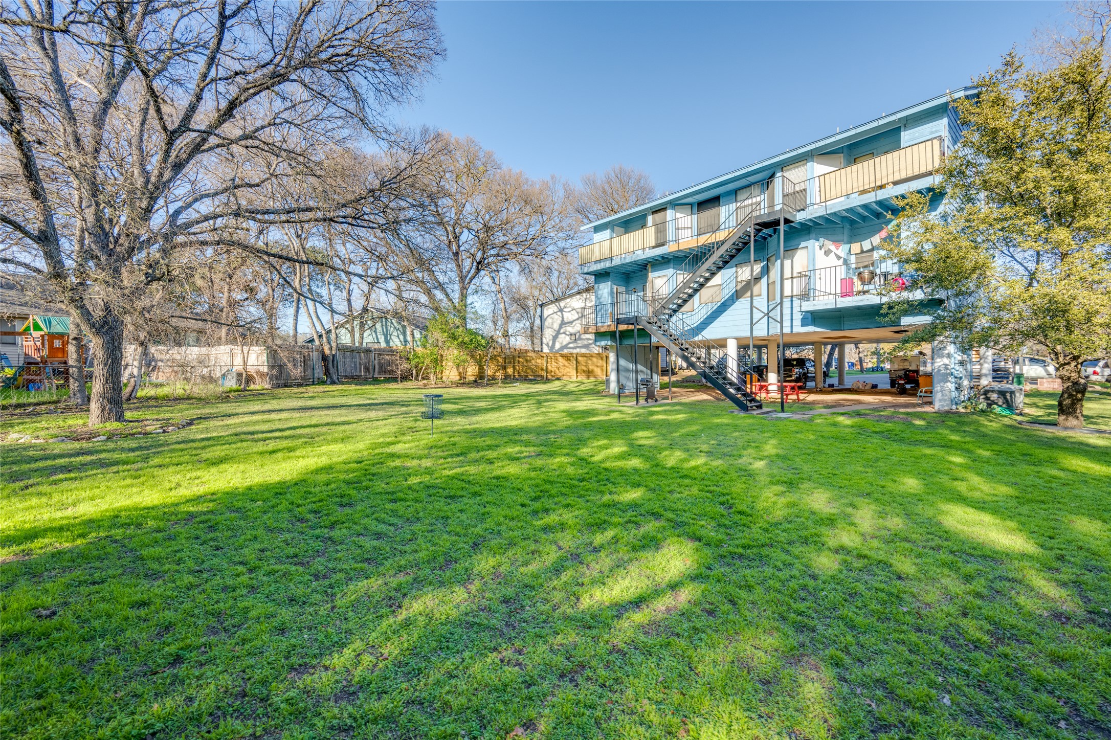 5304 Indio Cove, Unit B Austin, TX 78745 - Photo 37 of 40 a view of a building with a big yard and large trees