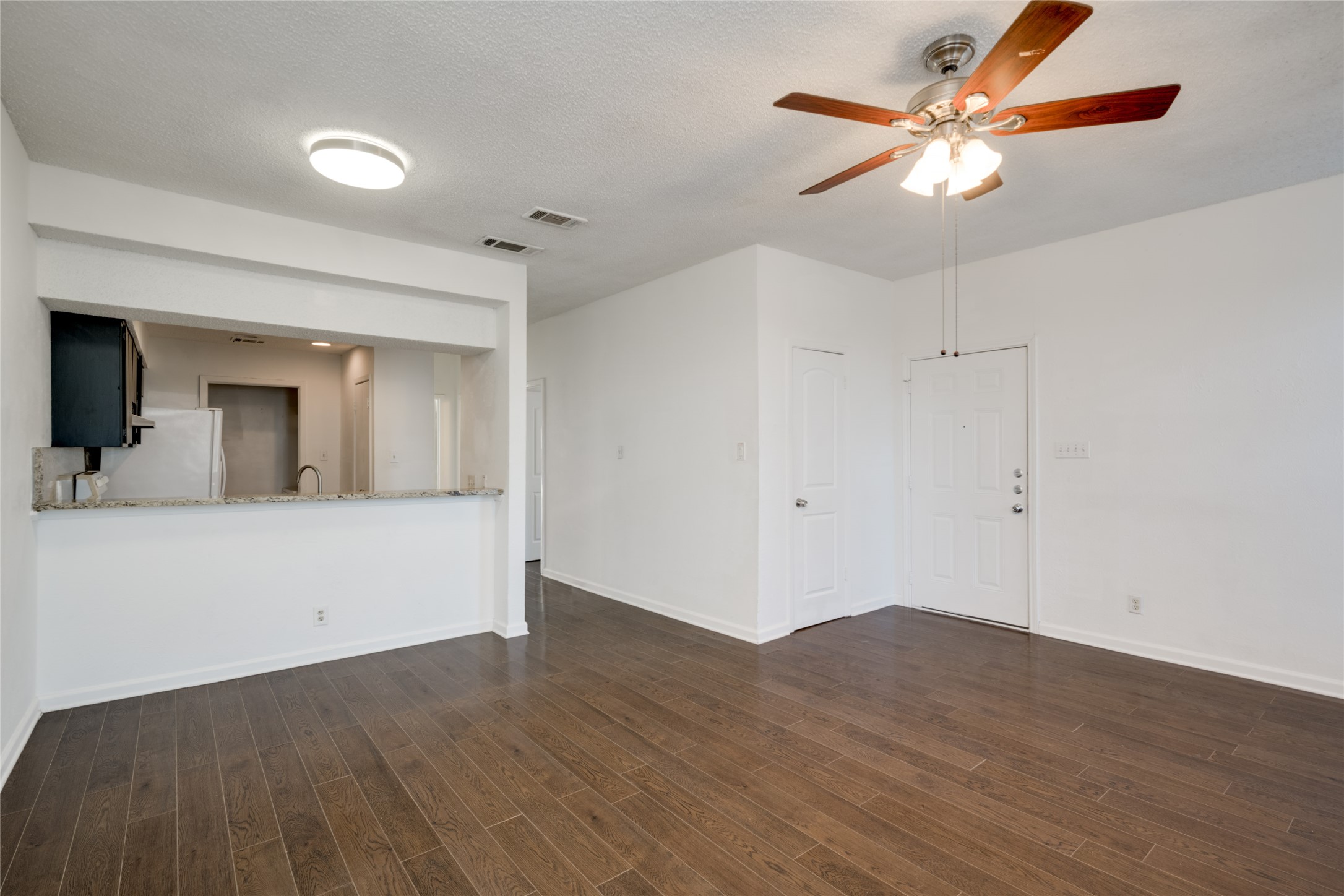 5304 Indio Cove, Unit B Austin, TX 78745 - Photo 4 of 40 a view of a room with wooden floor and a ceiling fan