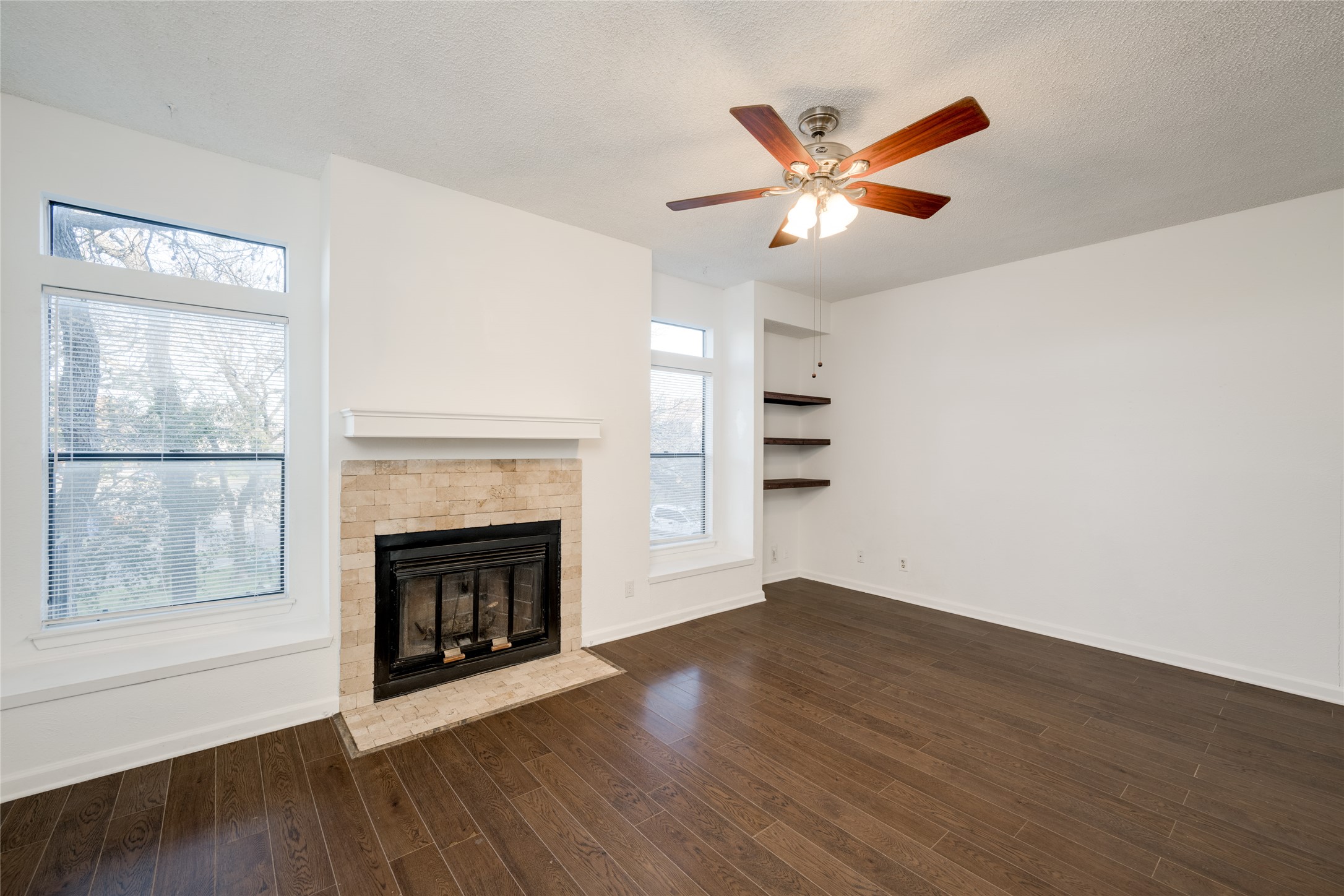 5304 Indio Cove, Unit B Austin, TX 78745 - Photo 7 of 40 an empty room with wooden floor fireplace and windows
