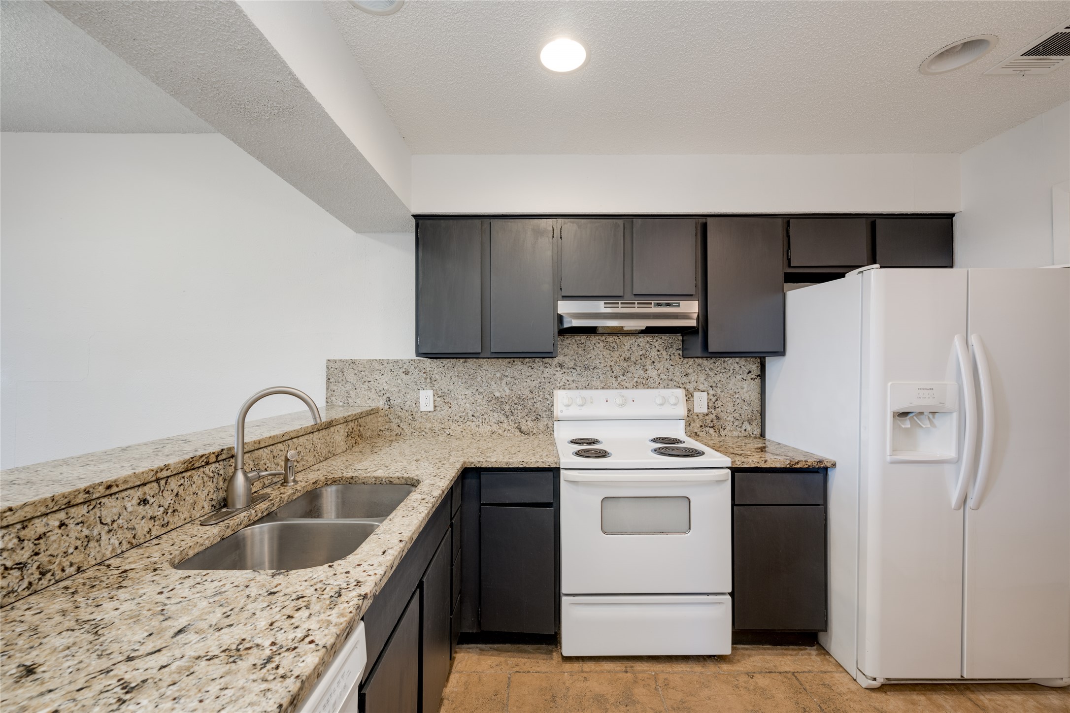 5304 Indio Cove, Unit B Austin, TX 78745 - Photo 10 of 40 a kitchen with stainless steel appliances granite countertop a sink stove and refrigerator