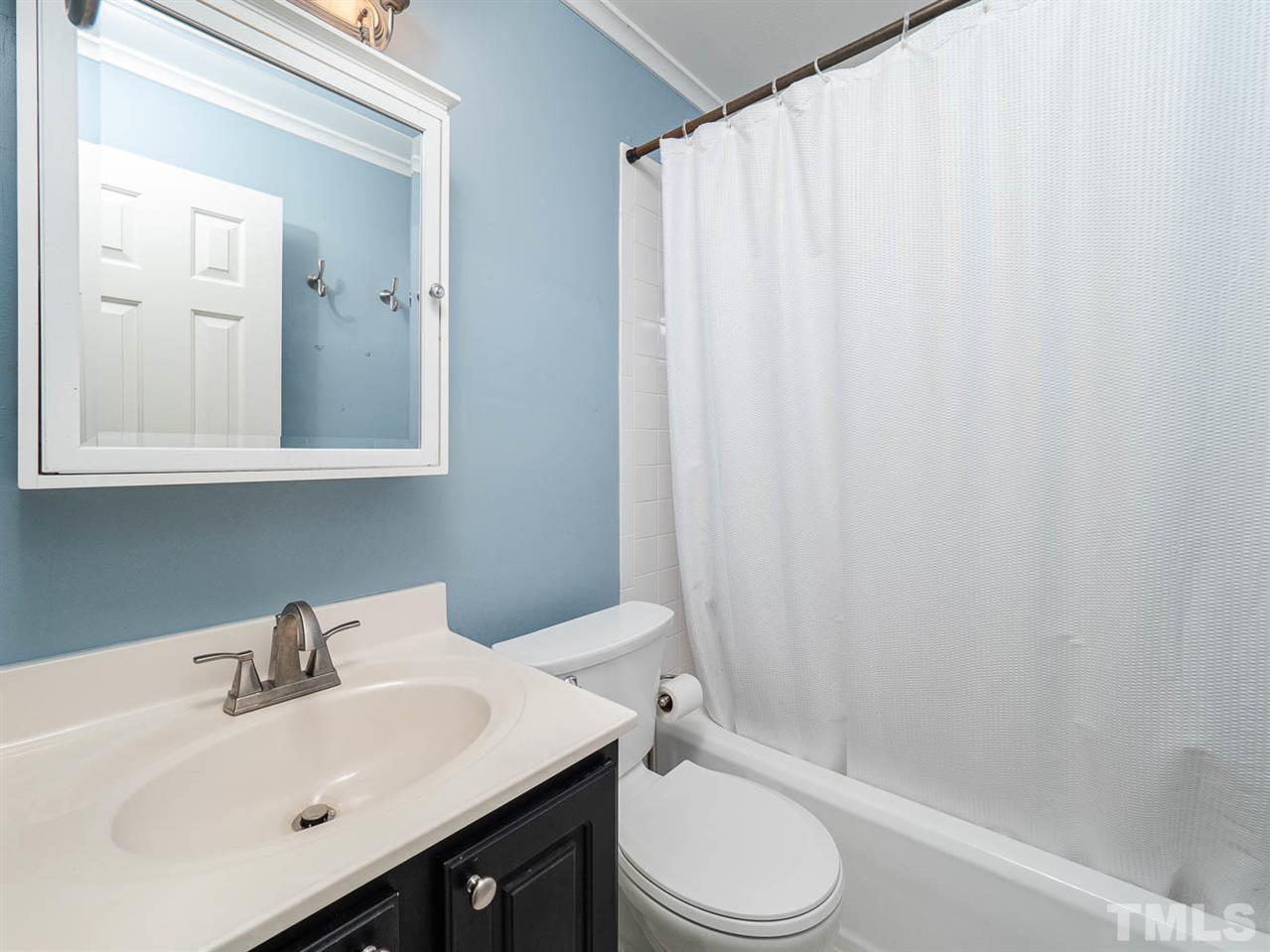 633 Daniels Street, Unit D Raleigh, NC 27605 - Photo 11 of 14 a bathroom with a sink toilet and shower