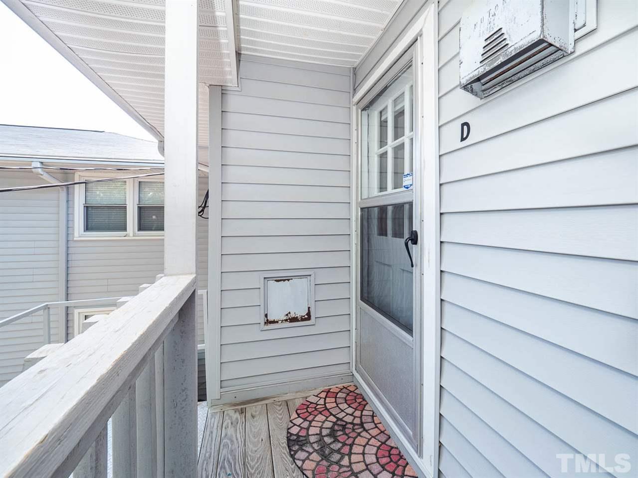 633 Daniels Street, Unit D Raleigh, NC 27605 - Photo 12 of 14 a balcony view with a wooden door