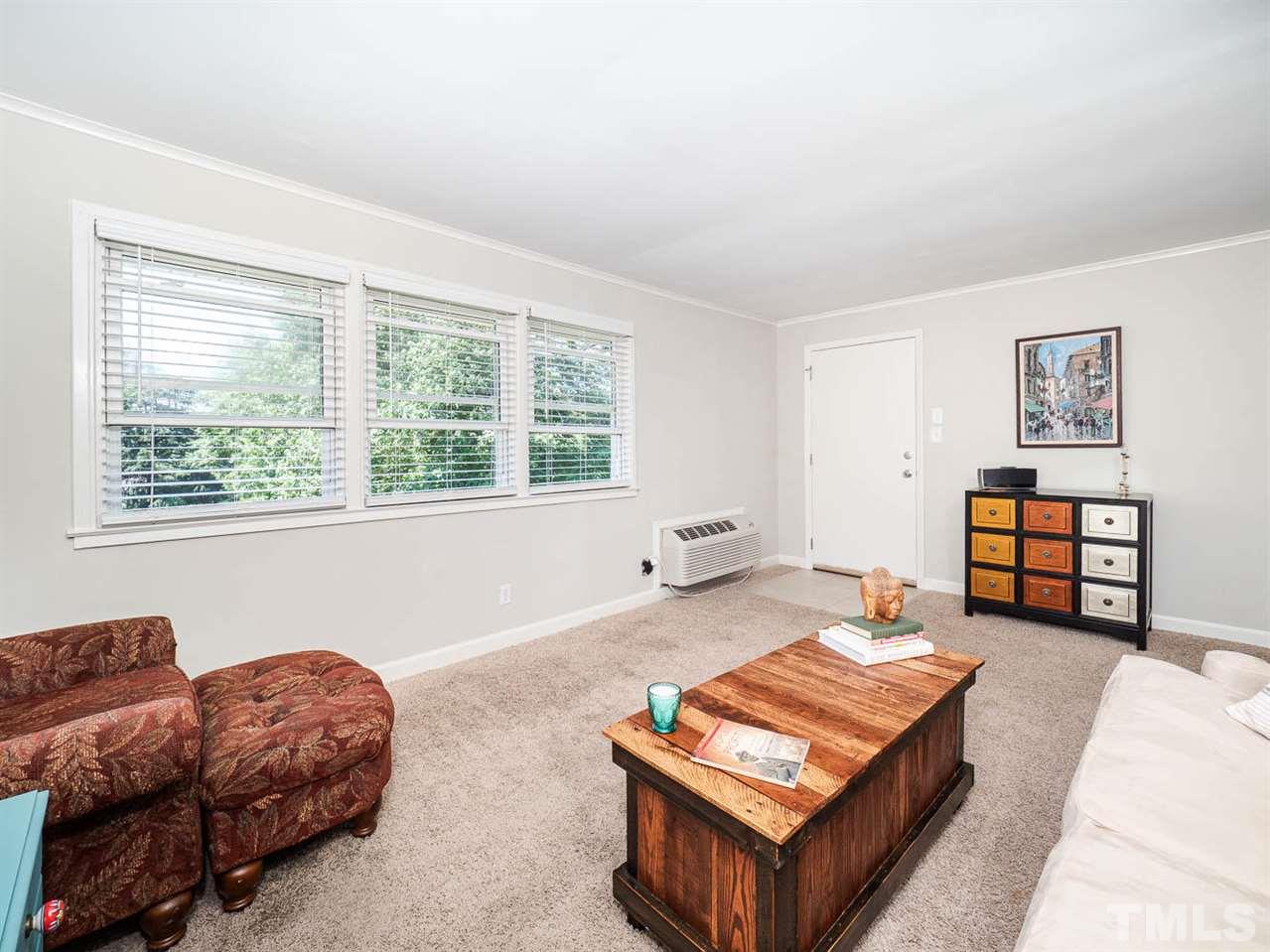 633 Daniels Street, Unit D Raleigh, NC 27605 - Photo 8 of 14 a living room with furniture and a window