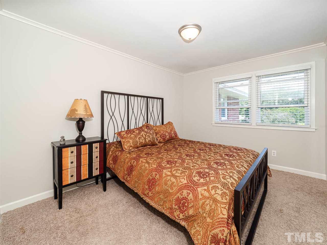 633 Daniels Street, Unit D Raleigh, NC 27605 - Photo 10 of 14 a bedroom with a bed and window