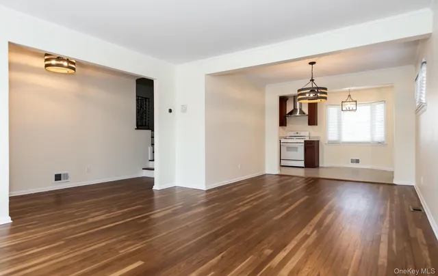 a view of a kitchen with wooden floor electronic appliances and window
