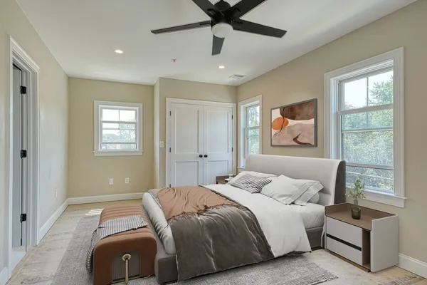 a bedroom with a bed and a window