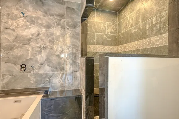 a bathroom with a bathtub and shower
