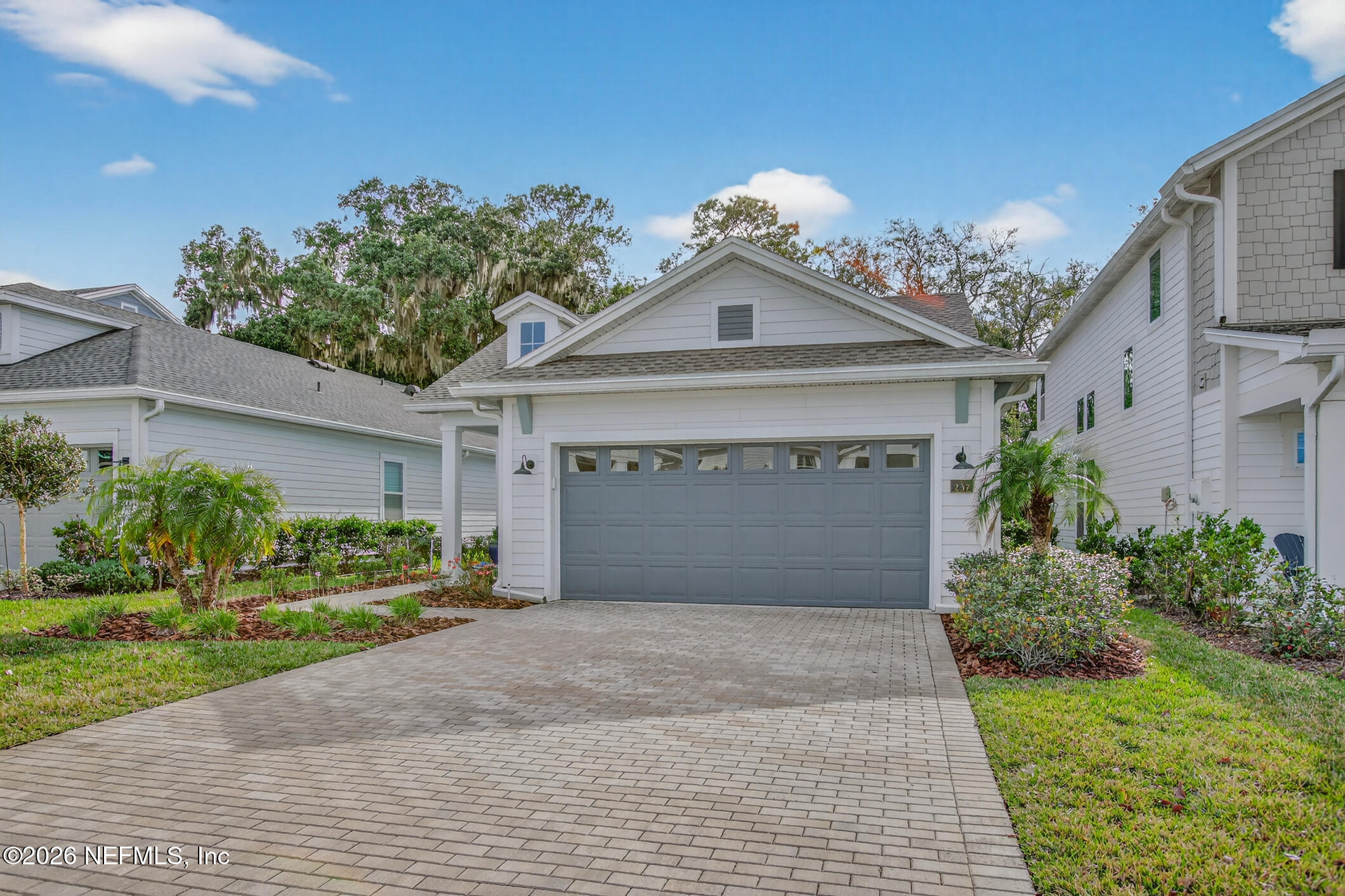 237 Windswept Way Street St. Augustine, FL 32092 - Photo 2 of 136 a front view of a house with a yard and garage