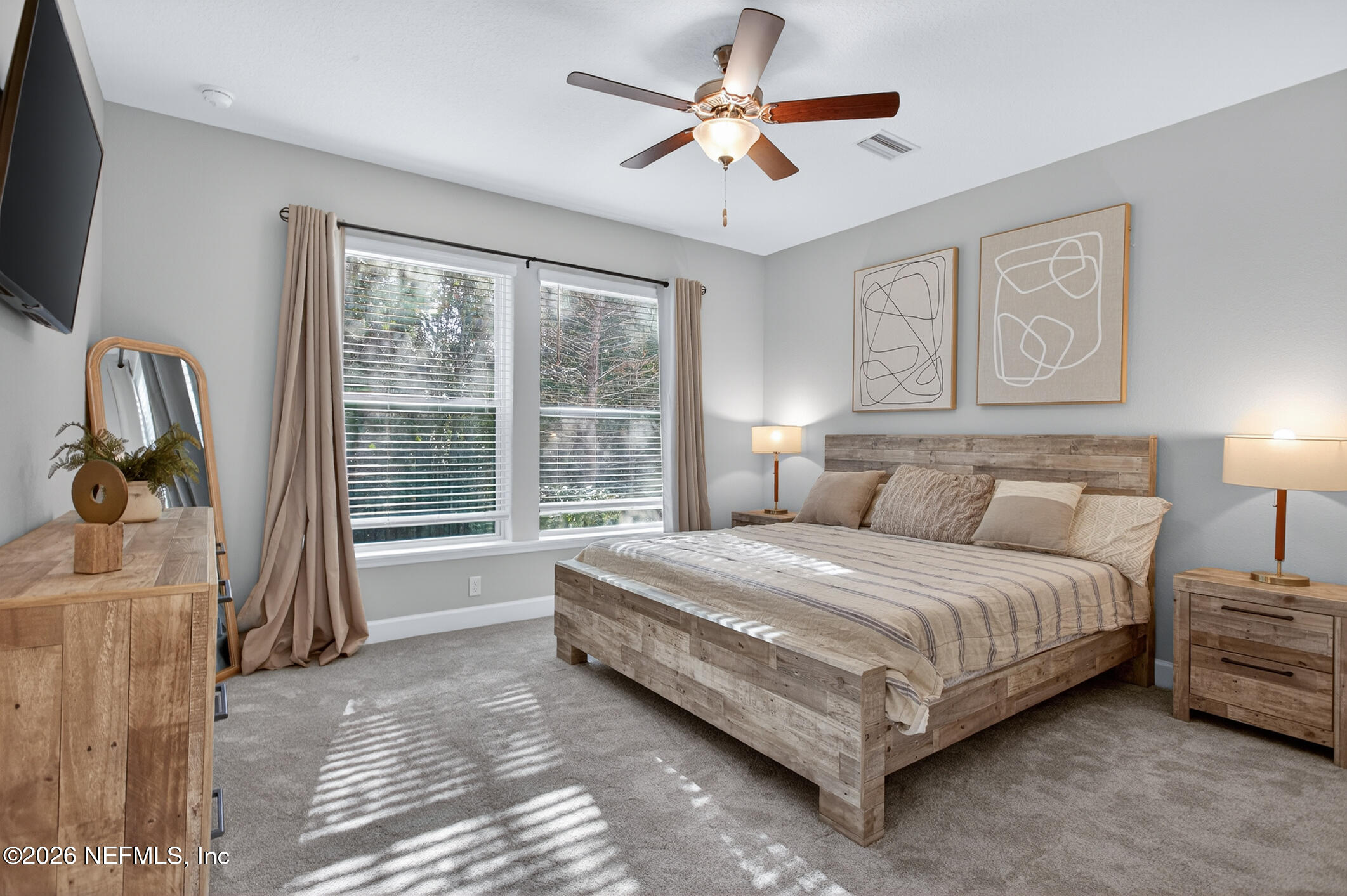 237 Windswept Way Street St. Augustine, FL 32092 - Photo 26 of 136 a spacious bedroom with a bed a dresser and a window