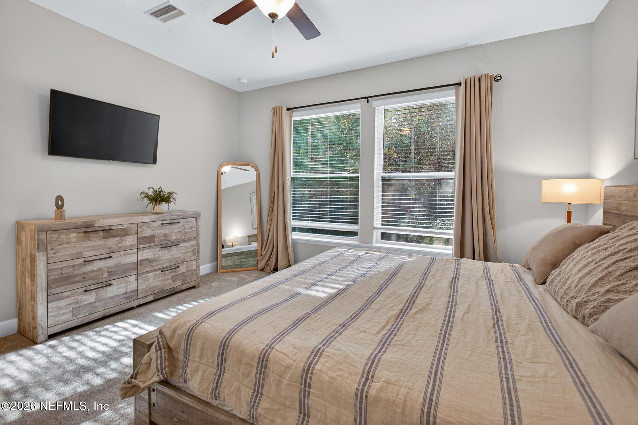 237 Windswept Way Street St. Augustine, FL 32092 - Photo 27 of 136 a bedroom with a large bed and flat tv screen on dresser