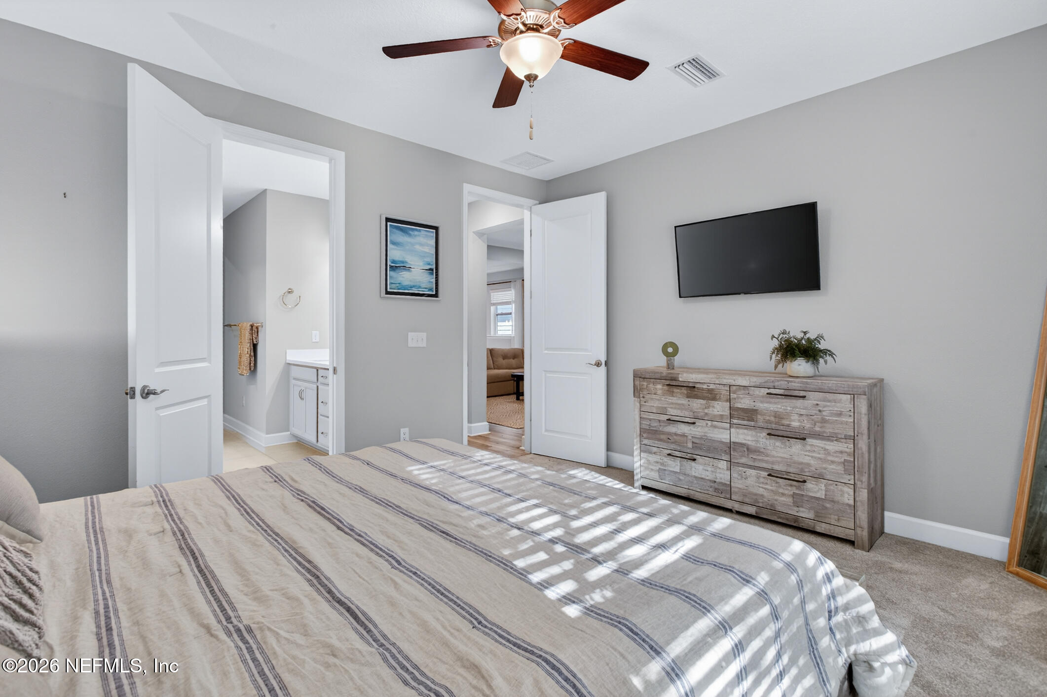 237 Windswept Way Street St. Augustine, FL 32092 - Photo 33 of 136 a bedroom with a bed and a flat screen tv