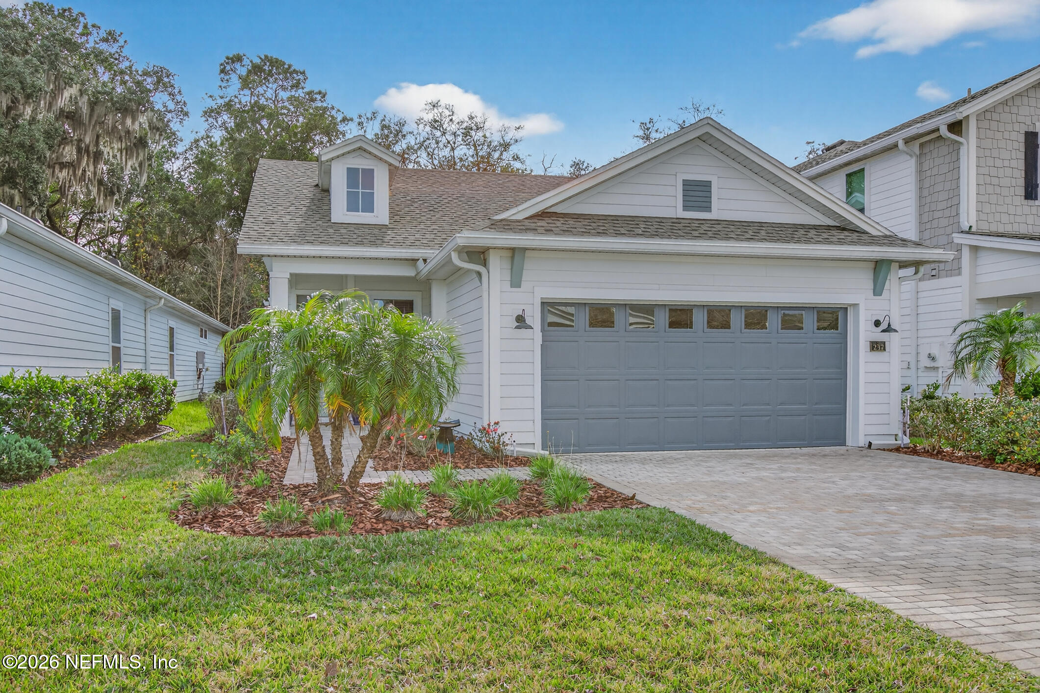 237 Windswept Way Street St. Augustine, FL 32092 - Photo 4 of 136 a front view of a house with a yard and garage