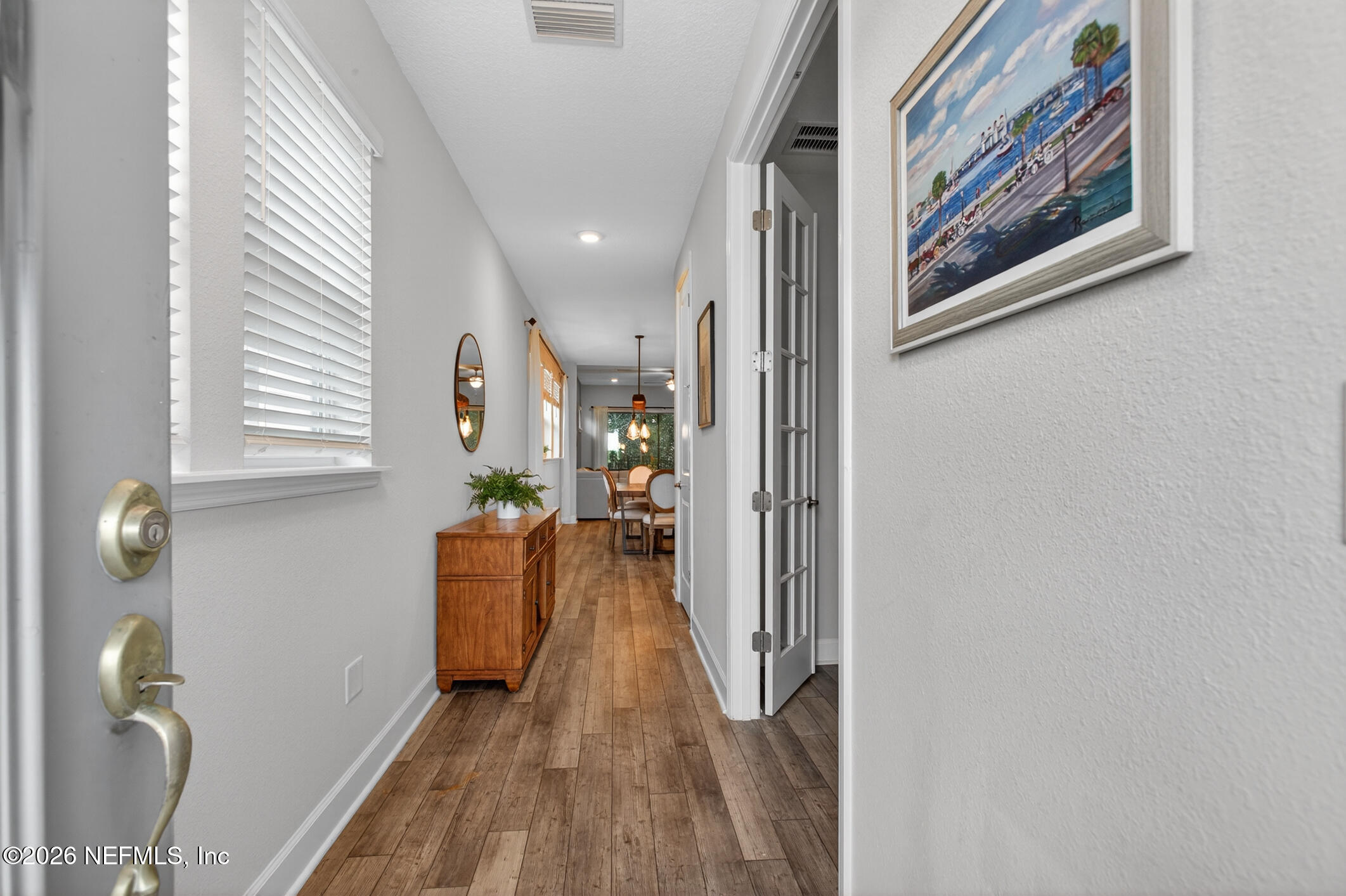 237 Windswept Way Street St. Augustine, FL 32092 - Photo 7 of 136 a view of a hallway with wooden floor and staircase