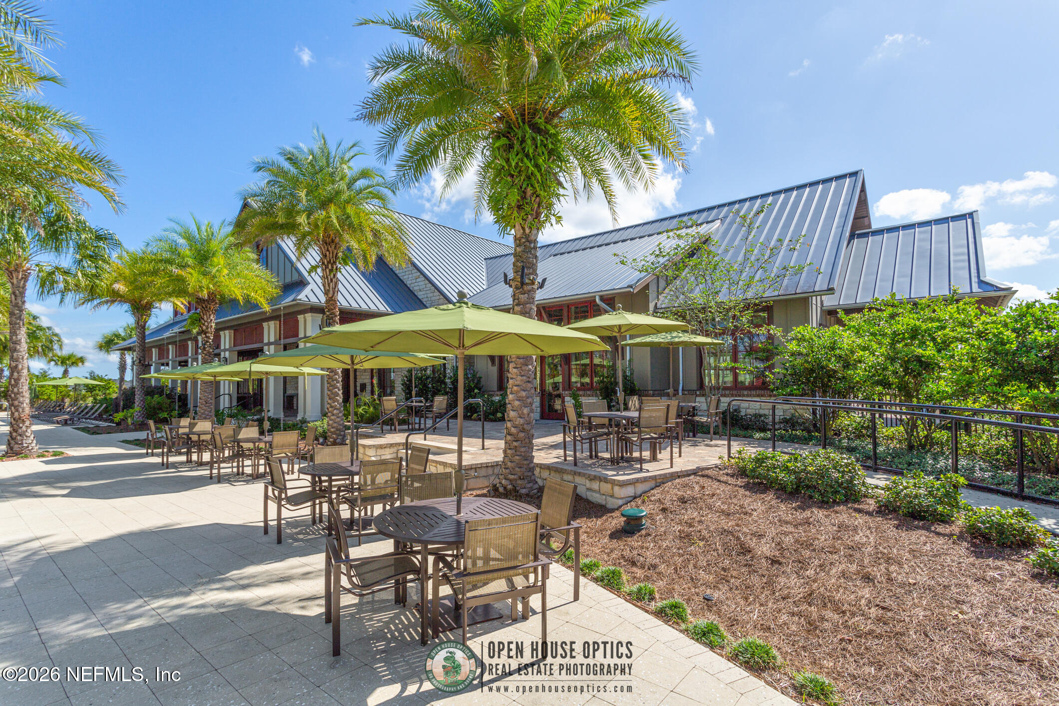 237 Windswept Way Street St. Augustine, FL 32092 - Photo 77 of 136 a patio with a table and chairs under an umbrella