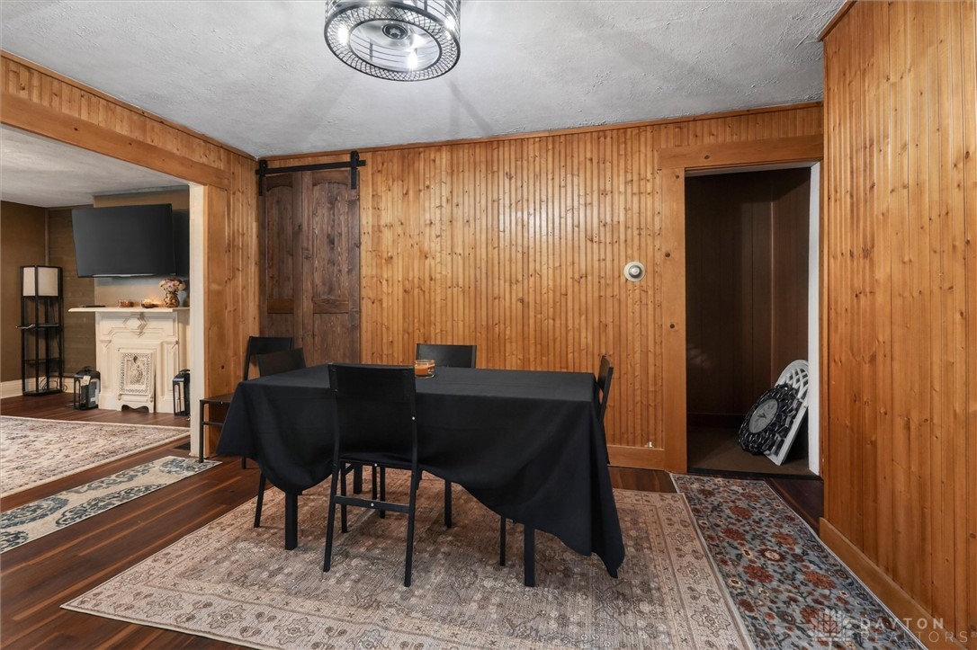 1726 Morgan Street Springfield, OH 45503 - Photo 10 of 30 This warm dining space features wood paneling and a striking chandelier, creating an inviting atmosphere.