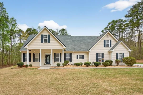 a front view of a house with a garden and patio