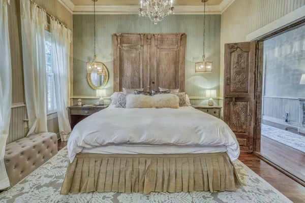 a living room with furniture a chandelier and a rug
