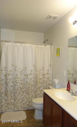 11026 West Elm Street Phoenix, AZ 85037 - Photo 12 of 20 a bathroom with a granite countertop sink and a toilet