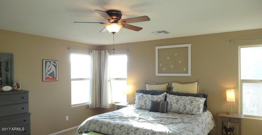 11026 West Elm Street Phoenix, AZ 85037 - Photo 13 of 20 a bedroom with a large bed and a window