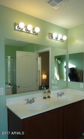 11026 West Elm Street Phoenix, AZ 85037 - Photo 14 of 20 a bathroom with a sink and a mirror