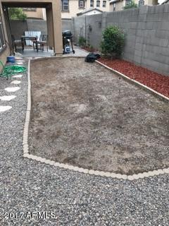 11026 West Elm Street Phoenix, AZ 85037 - Photo 17 of 20 a view of a backyard of a building