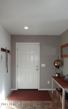 11026 West Elm Street Phoenix, AZ 85037 - Photo 2 of 20 a view of an entryway with wooden floor