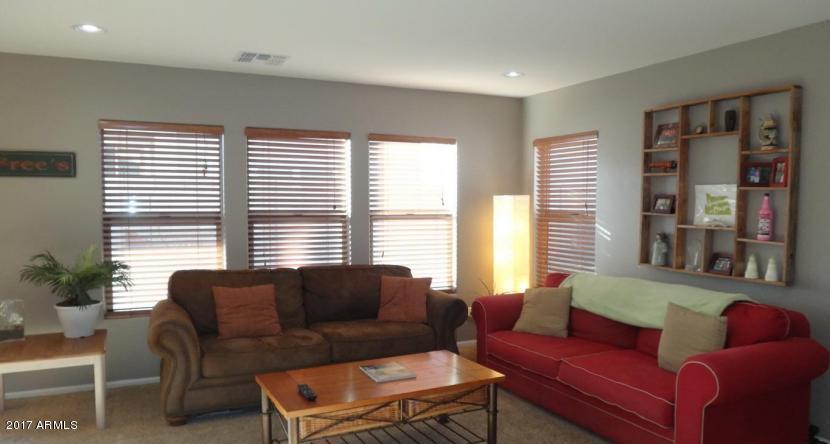 11026 West Elm Street Phoenix, AZ 85037 - Photo 3 of 20 a living room with furniture and a large window