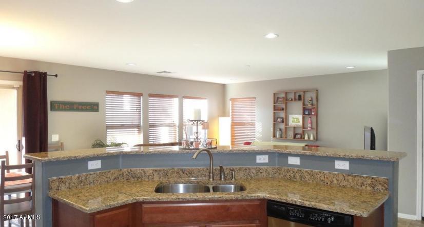 11026 West Elm Street Phoenix, AZ 85037 - Photo 7 of 20 a kitchen with granite countertop a sink and a window