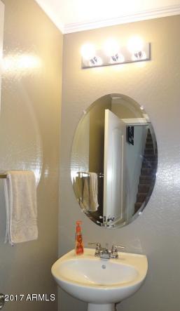 11026 West Elm Street Phoenix, AZ 85037 - Photo 8 of 20 a bathroom with a sink and mirror