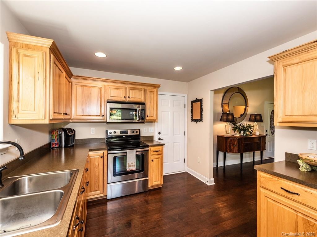 2910 Ruben Road Monroe, NC 28112 - Photo 11 of 29 a kitchen with stainless steel appliances granite countertop a stove and a sink