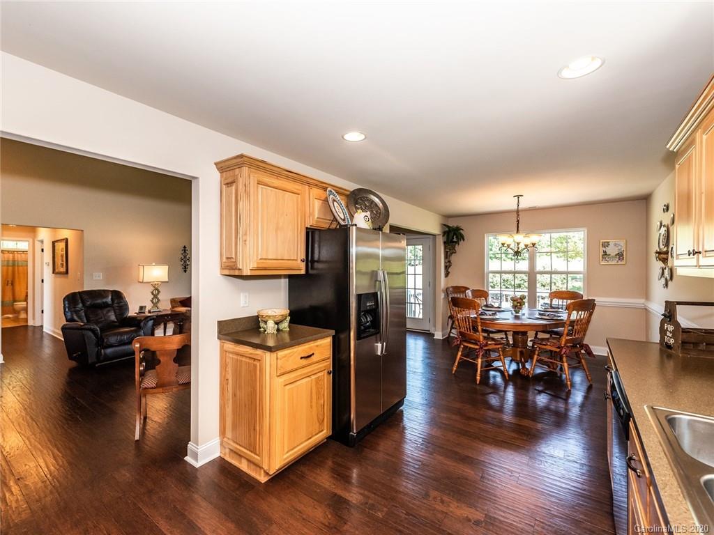 2910 Ruben Road Monroe, NC 28112 - Photo 12 of 29 a living room with furniture dining table wooden floor and a large window