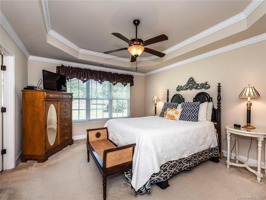 2910 Ruben Road Monroe, NC 28112 - Photo 15 of 29 a bed room with a bed and a chandelier