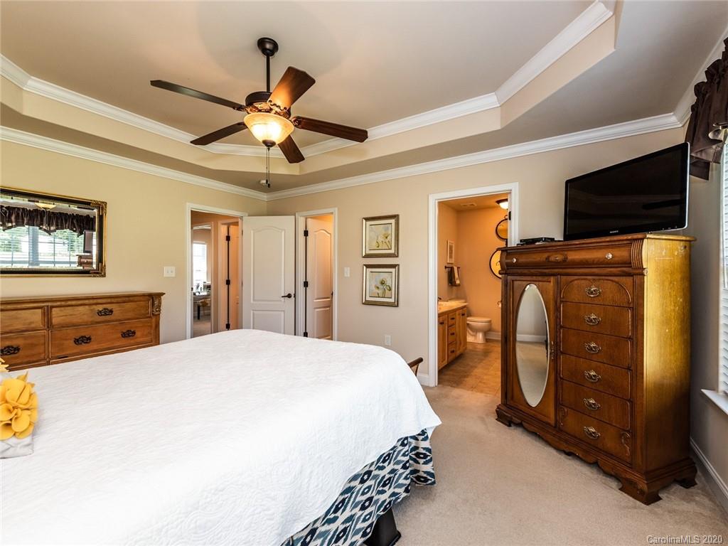 2910 Ruben Road Monroe, NC 28112 - Photo 17 of 29 a bedroom with a bed and a chandelier
