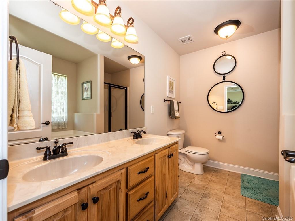 2910 Ruben Road Monroe, NC 28112 - Photo 18 of 29 a bathroom with a sink vanity granite toilet and a mirror