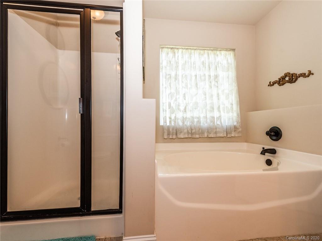 2910 Ruben Road Monroe, NC 28112 - Photo 19 of 29 a white bath tub sitting next to a window