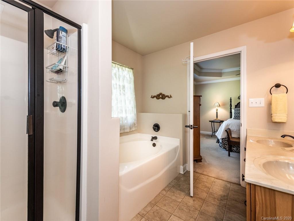 2910 Ruben Road Monroe, NC 28112 - Photo 20 of 29 a en suite bathroom with a tub shower and a mirror