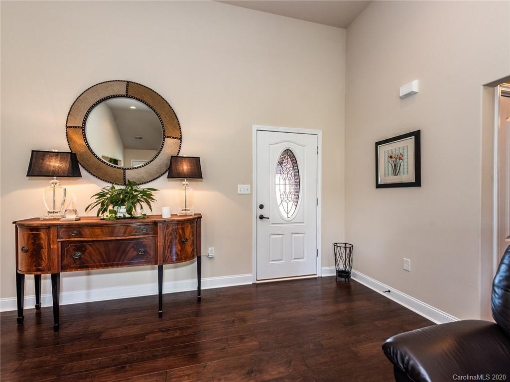 2910 Ruben Road Monroe, NC 28112 - Photo 3 of 29 a living room with furniture a mirror and wooden floor
