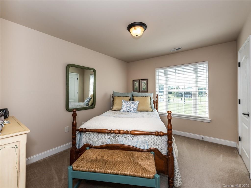 2910 Ruben Road Monroe, NC 28112 - Photo 22 of 29 a bedroom with a bed mirror and window