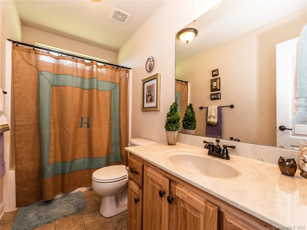 2910 Ruben Road Monroe, NC 28112 - Photo 23 of 29 a bathroom with a sink toilet a mirror and shower curtain