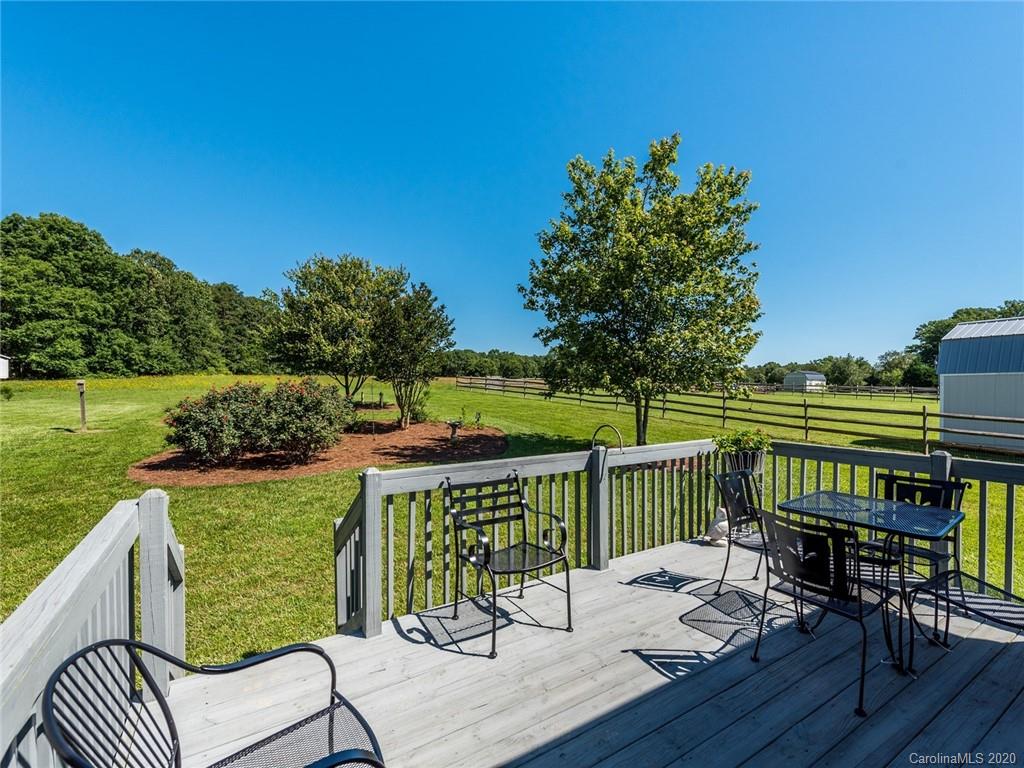 2910 Ruben Road Monroe, NC 28112 - Photo 24 of 29 a view of a deck with chair and wooden floor