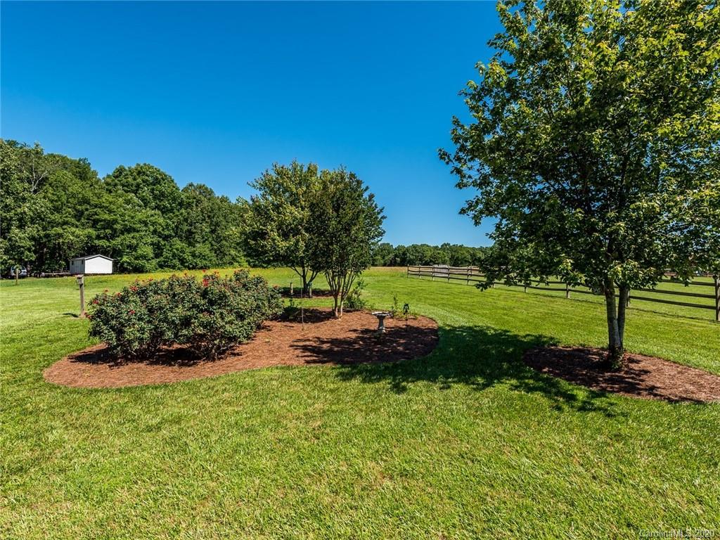 2910 Ruben Road Monroe, NC 28112 - Photo 25 of 29 a view of a garden with a lake