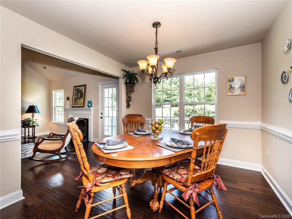 2910 Ruben Road Monroe, NC 28112 - Photo 9 of 29 a dining room with furniture a chandelier and wooden floor