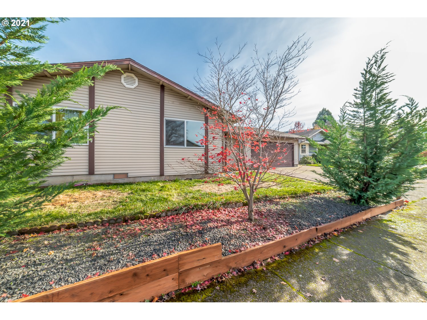 471 67th Street Springfield, OR 97478 - Photo 2 of 28 a front view of a house with a yard and garage