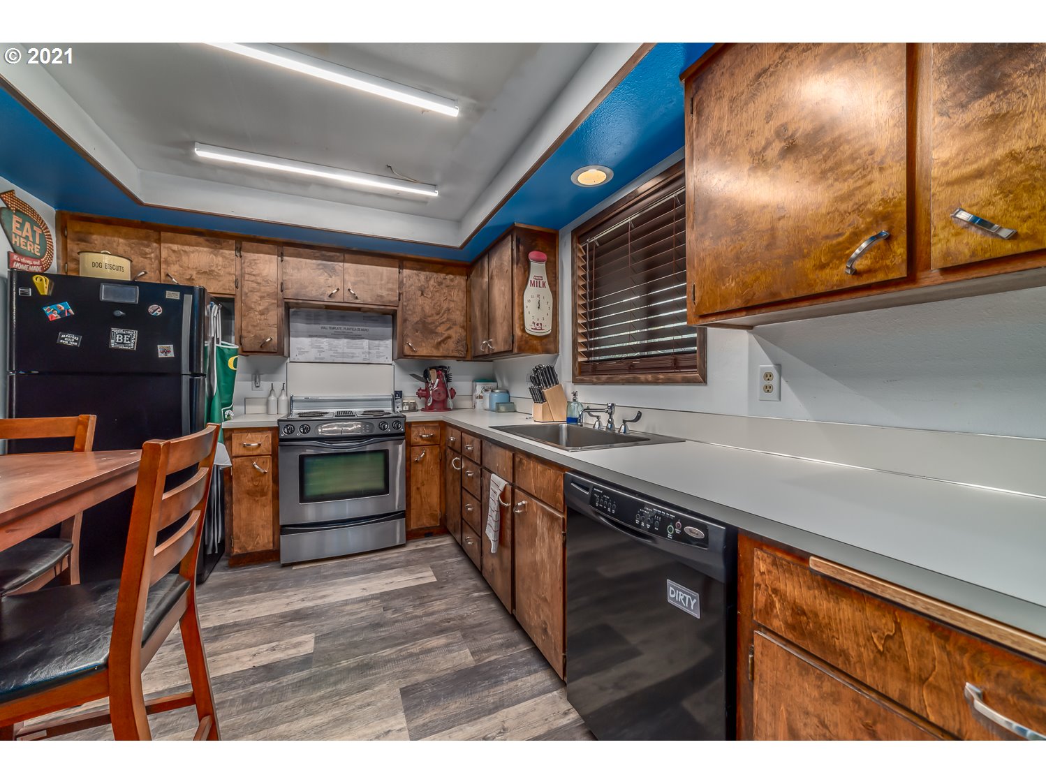 471 67th Street Springfield, OR 97478 - Photo 11 of 28 a kitchen with stainless steel appliances granite countertop a stove a sink and a microwave