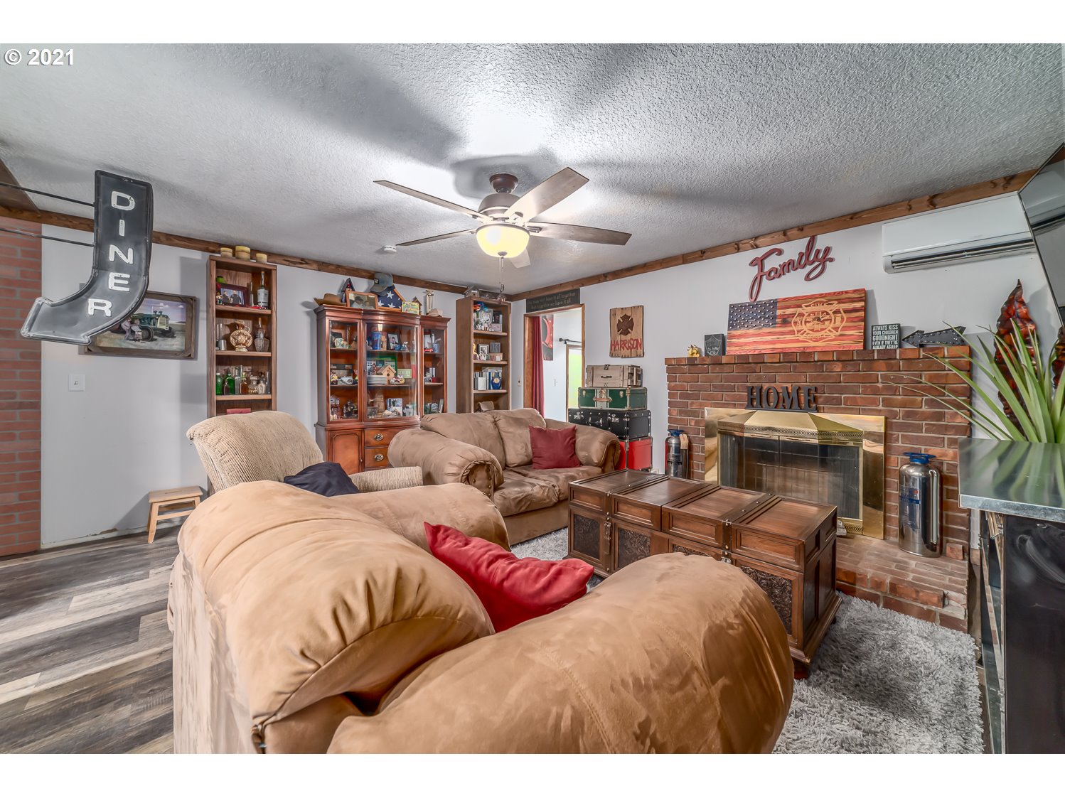 471 67th Street Springfield, OR 97478 - Photo 13 of 28 a living room with furniture a fireplace and a flat screen tv