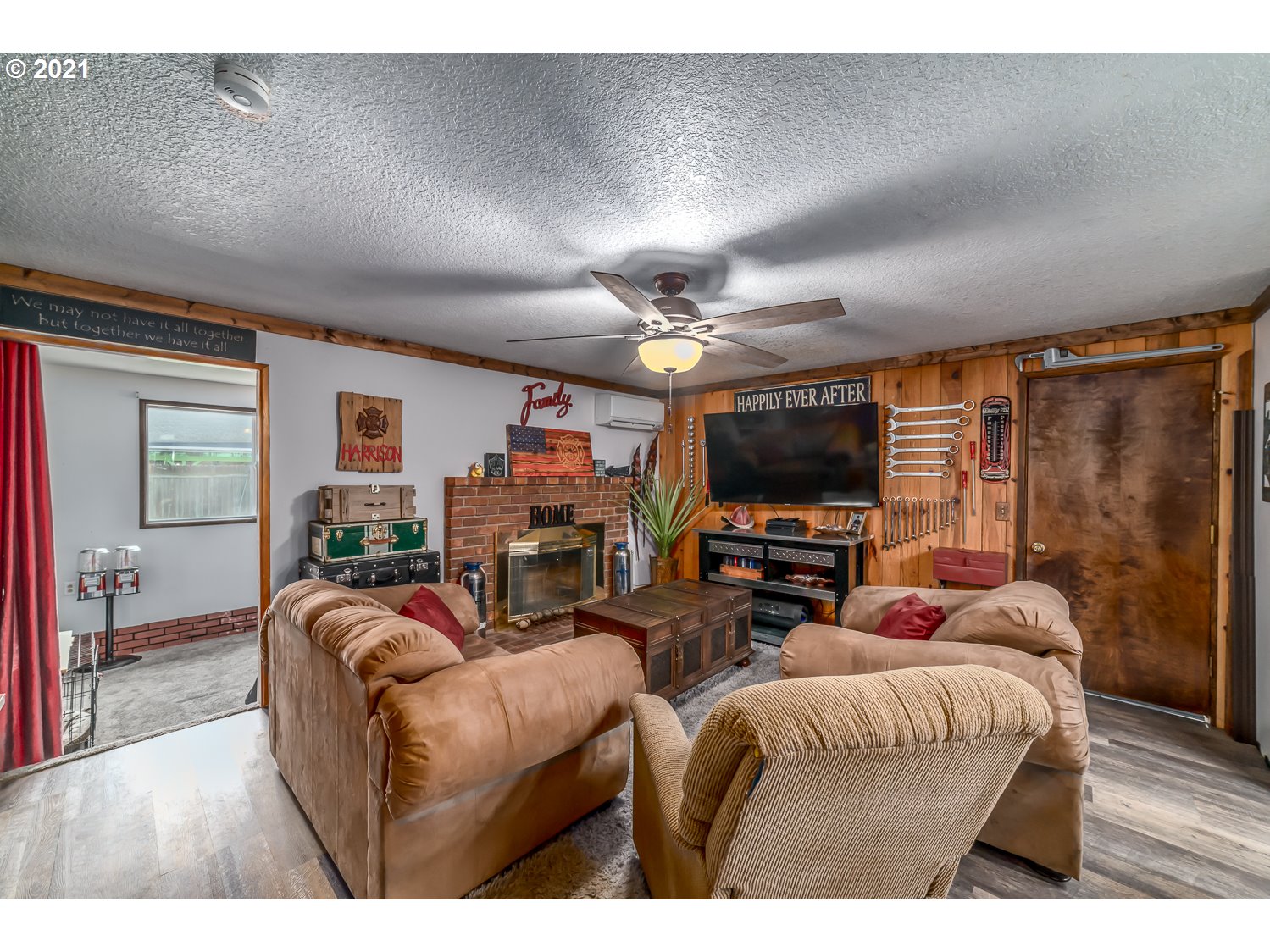 471 67th Street Springfield, OR 97478 - Photo 14 of 28 a living room with furniture a flat screen tv and a large window